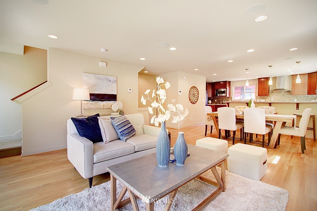 7757 Sand Point Way Northeast, Unit A Seattle, WA 98115 - Photo 10 of 25 a living room with lots of furniture and kitchen view
