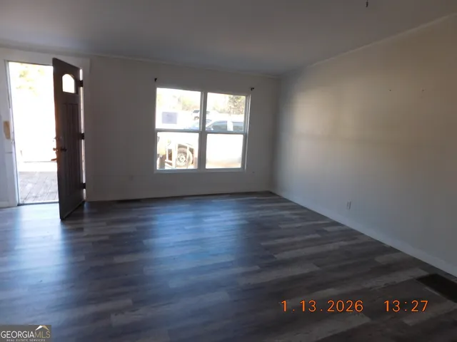 a kitchen with a sink and wooden floor