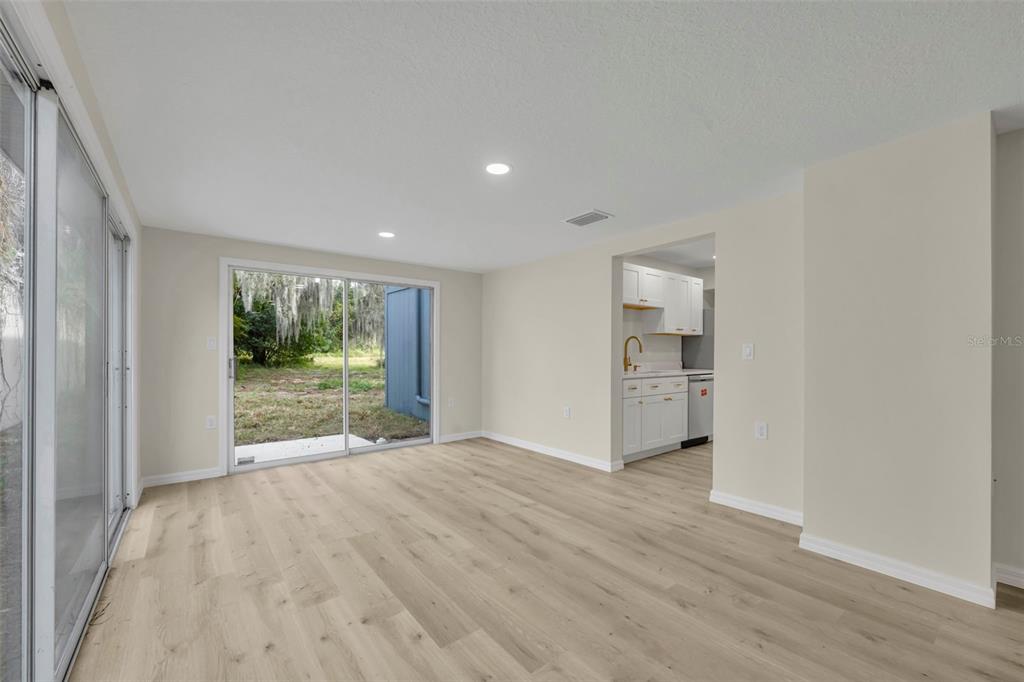 31201 Merry Road Tavares, FL 32778 - Photo 14 of 40 a view of empty room with wooden floor and fireplace