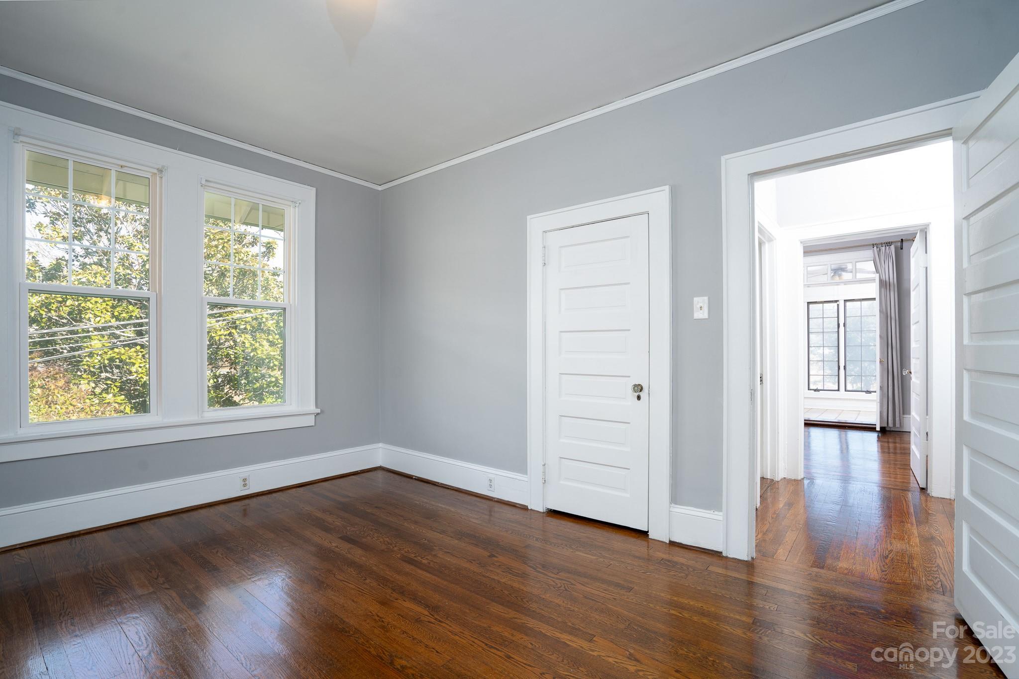 228 Providence Road Charlotte, NC 28207 - Photo 12 of 16 a view of an empty room with wooden floor and a window