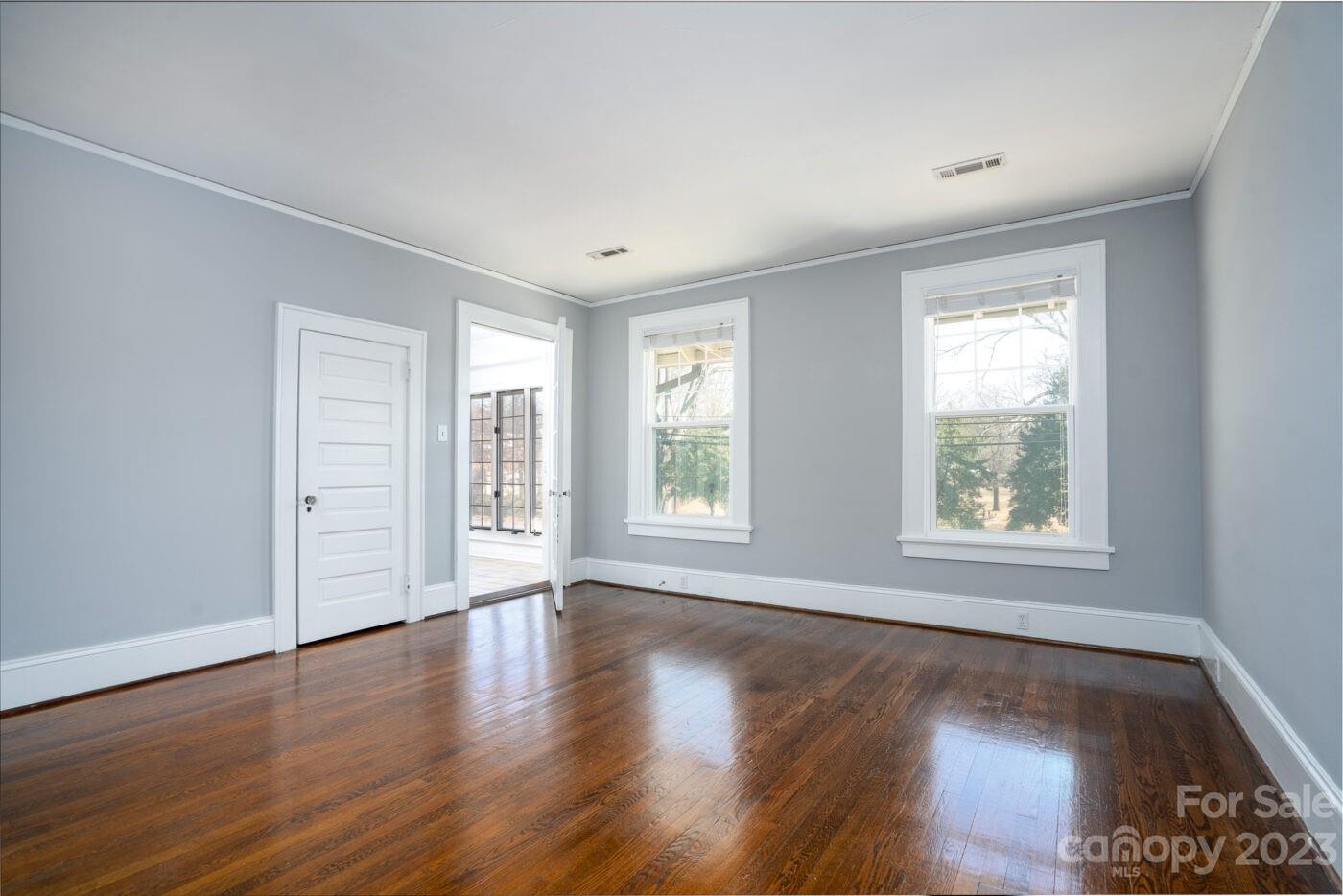 228 Providence Road Charlotte, NC 28207 - Photo 2 of 16 a view of an empty room with wooden floor and a window