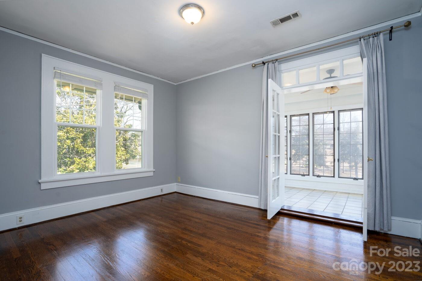228 Providence Road Charlotte, NC 28207 - Photo 3 of 16 a view of an empty room with wooden floor and a window