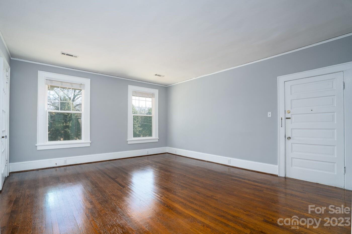 228 Providence Road Charlotte, NC 28207 - Photo 4 of 16 an empty room with wooden floor and windows