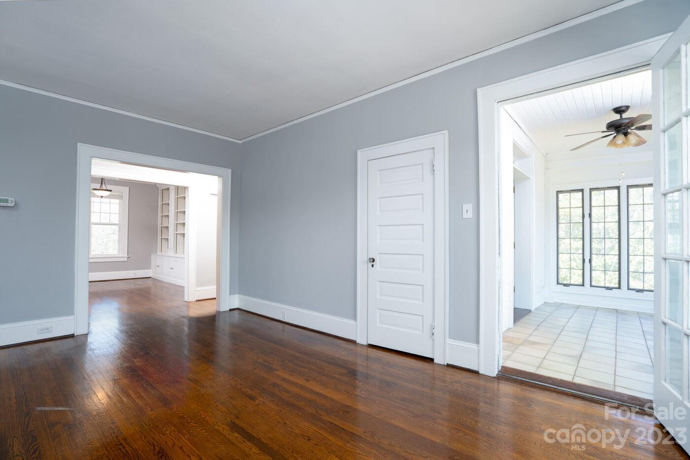 228 Providence Road Charlotte, NC 28207 - Photo 6 of 16 an empty room with wooden floor and windows