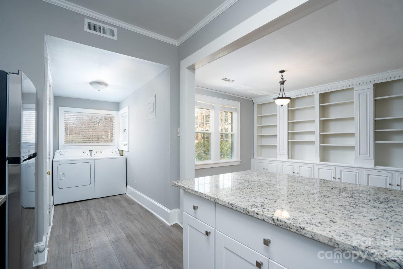 228 Providence Road Charlotte, NC 28207 - Photo 10 of 16 a view of a kitchen with a sink and dishwasher with wooden floor