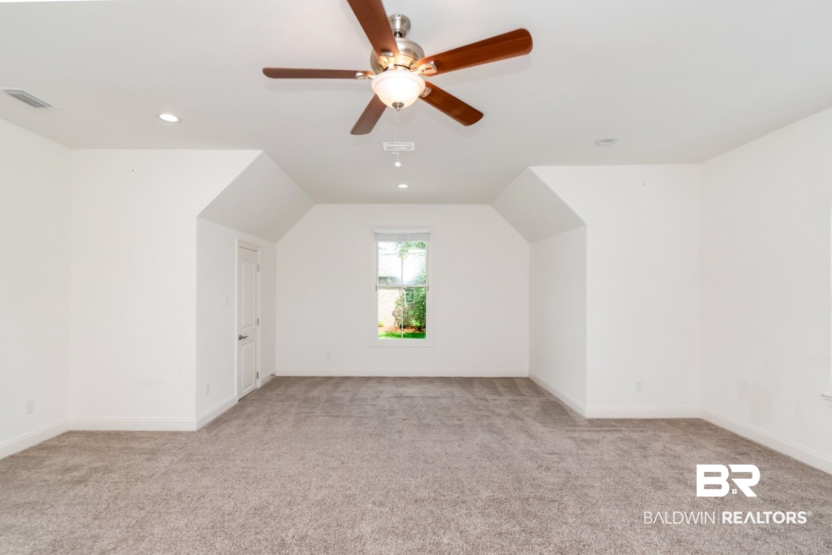 3528 Rue Royal Mobile, AL 36693 - Photo 42 of 53 Spacious room featuring vaulted ceilings, a ceiling fan with light fixture, recessed lighting, and soft carpet flooring