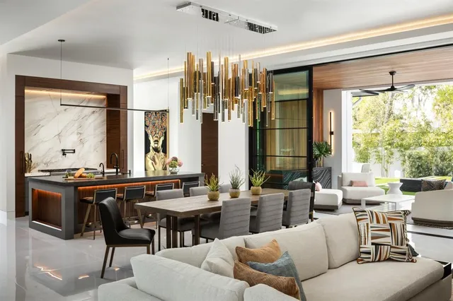 a living room with furniture and large windows