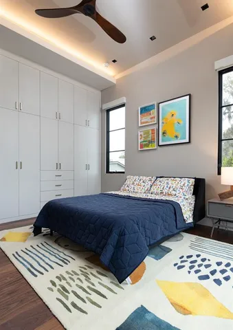 a bedroom with a bed and a painting on the wall