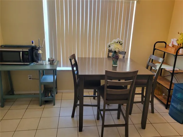 a dining room with furniture and window