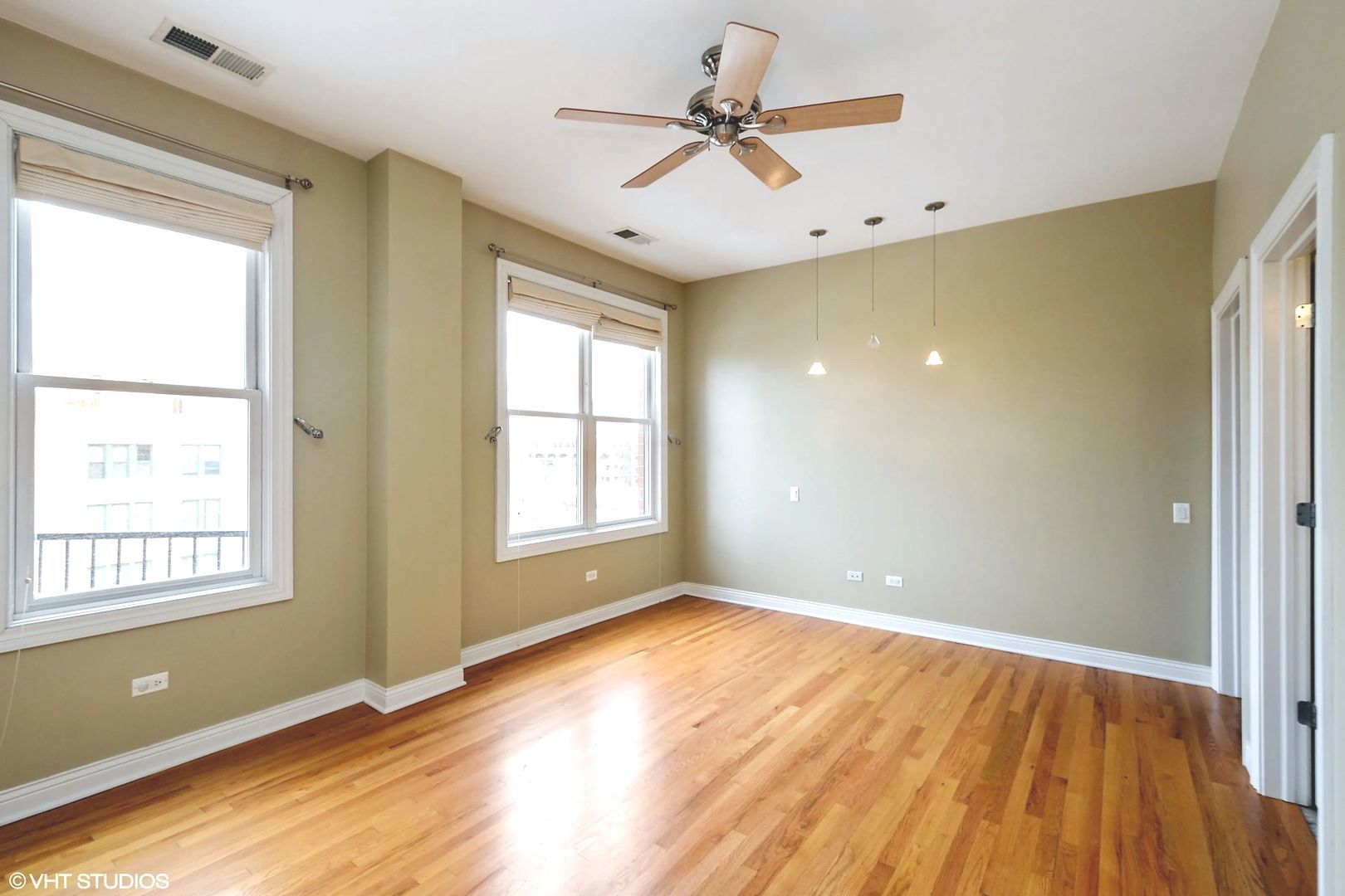 1355 West Washington Boulevard, Unit 6B Chicago, IL 60607 - Photo 11 of 28 a view of an empty room with window and wooden floor