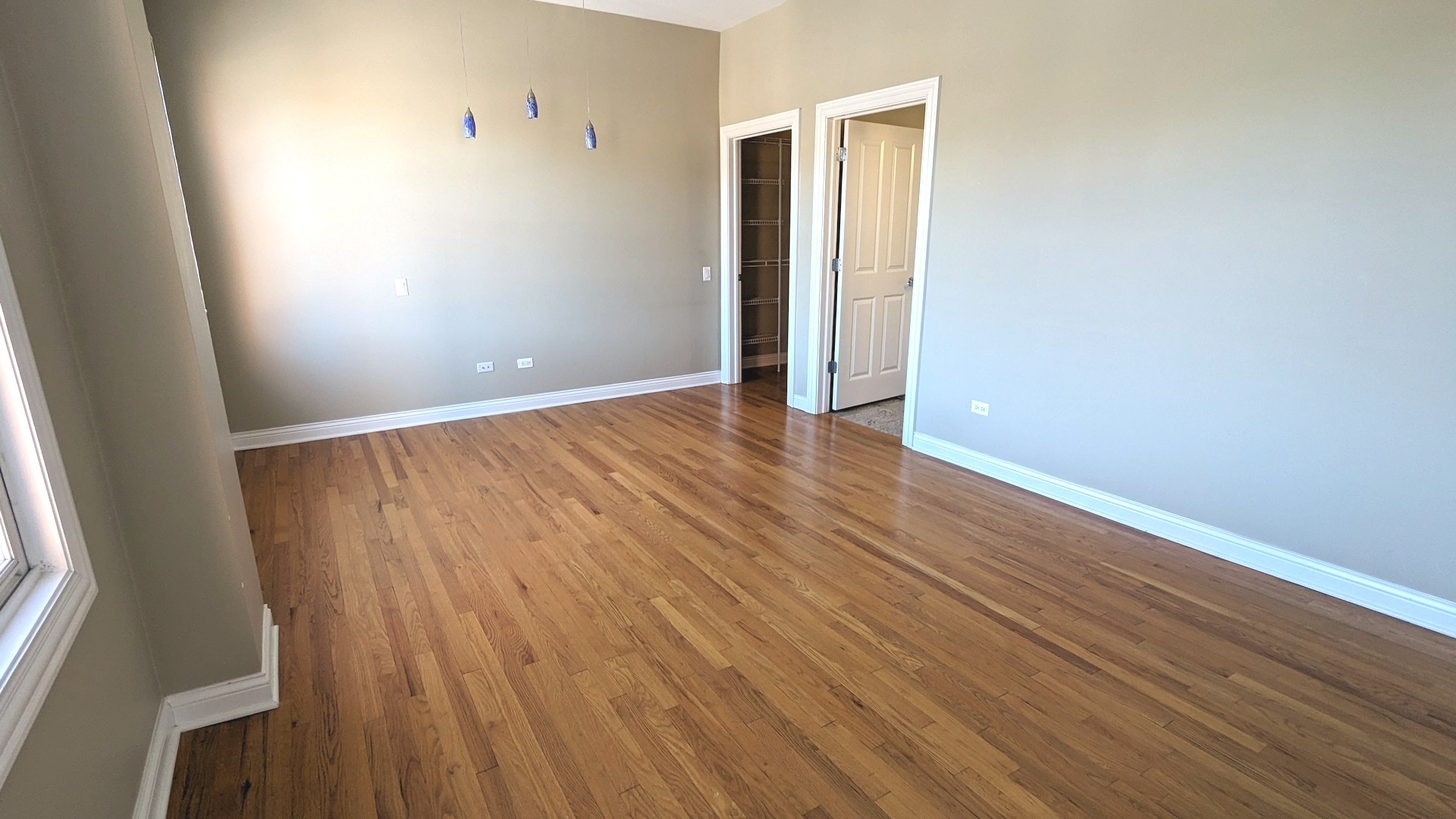 1355 West Washington Boulevard, Unit 6B Chicago, IL 60607 - Photo 13 of 28 an empty room with wooden floor and windows