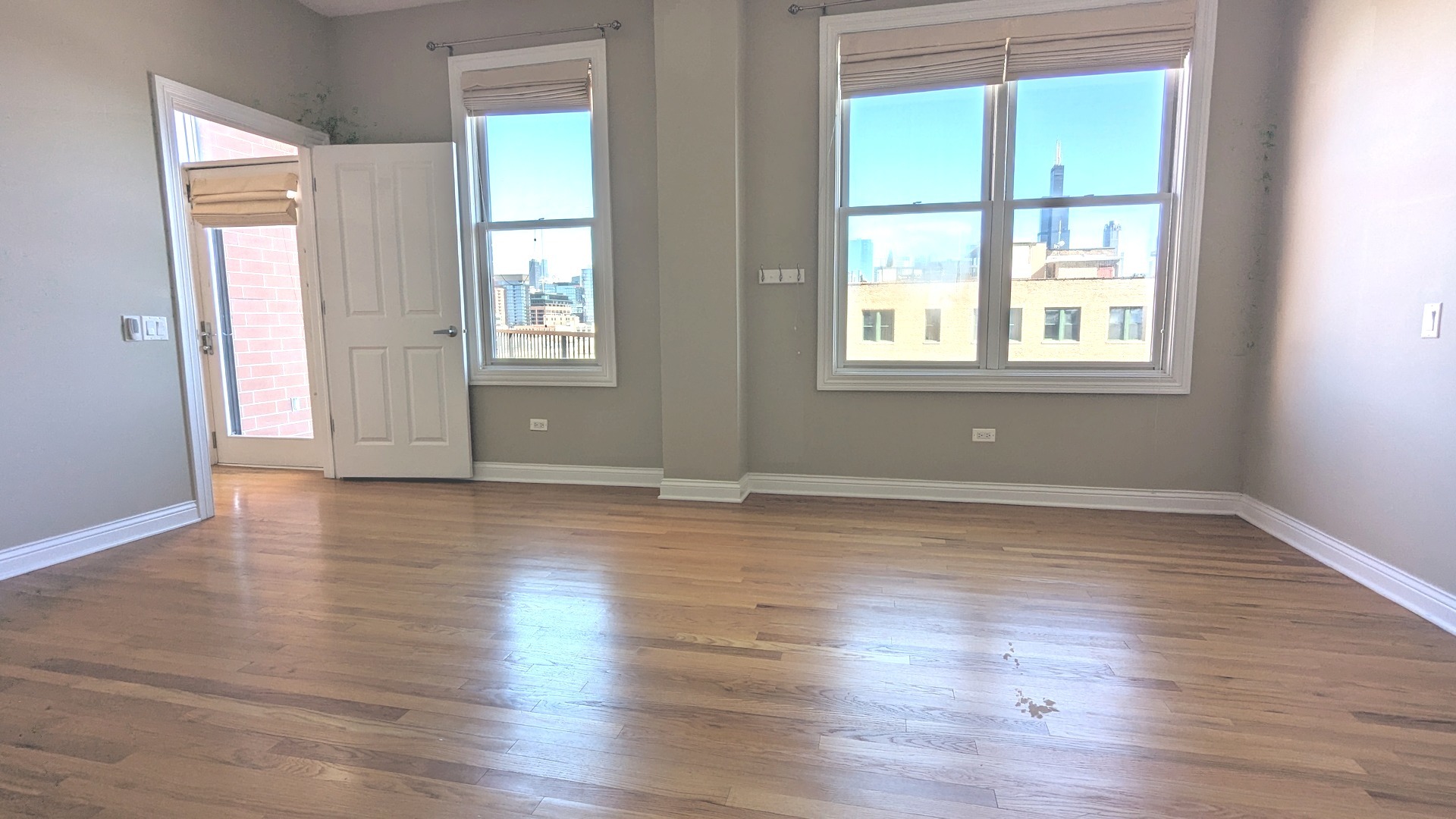 1355 West Washington Boulevard, Unit 6B Chicago, IL 60607 - Photo 14 of 28 an empty room with wooden floor and windows