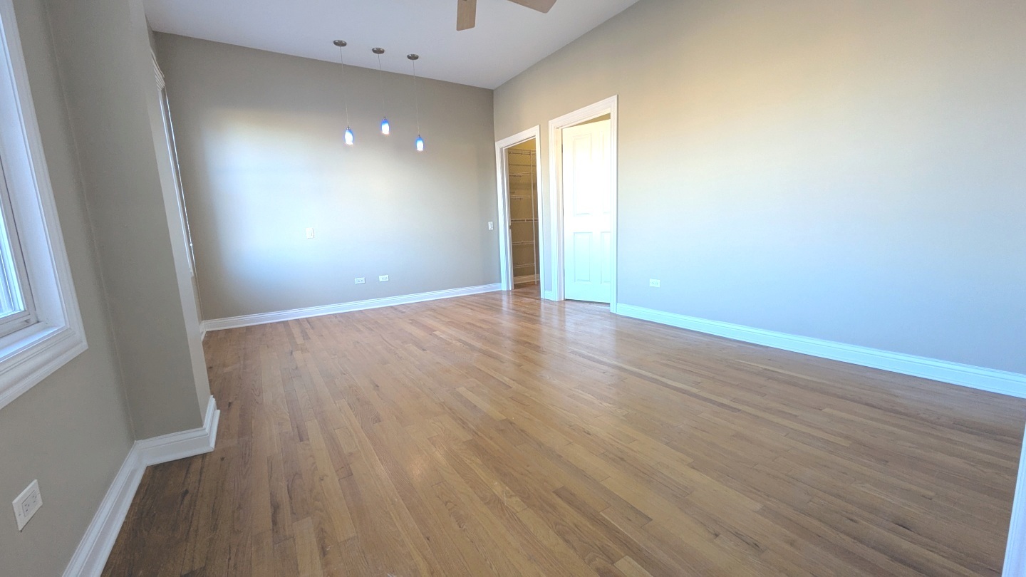 1355 West Washington Boulevard, Unit 6B Chicago, IL 60607 - Photo 15 of 28 a view of an empty room with wooden floor and a window