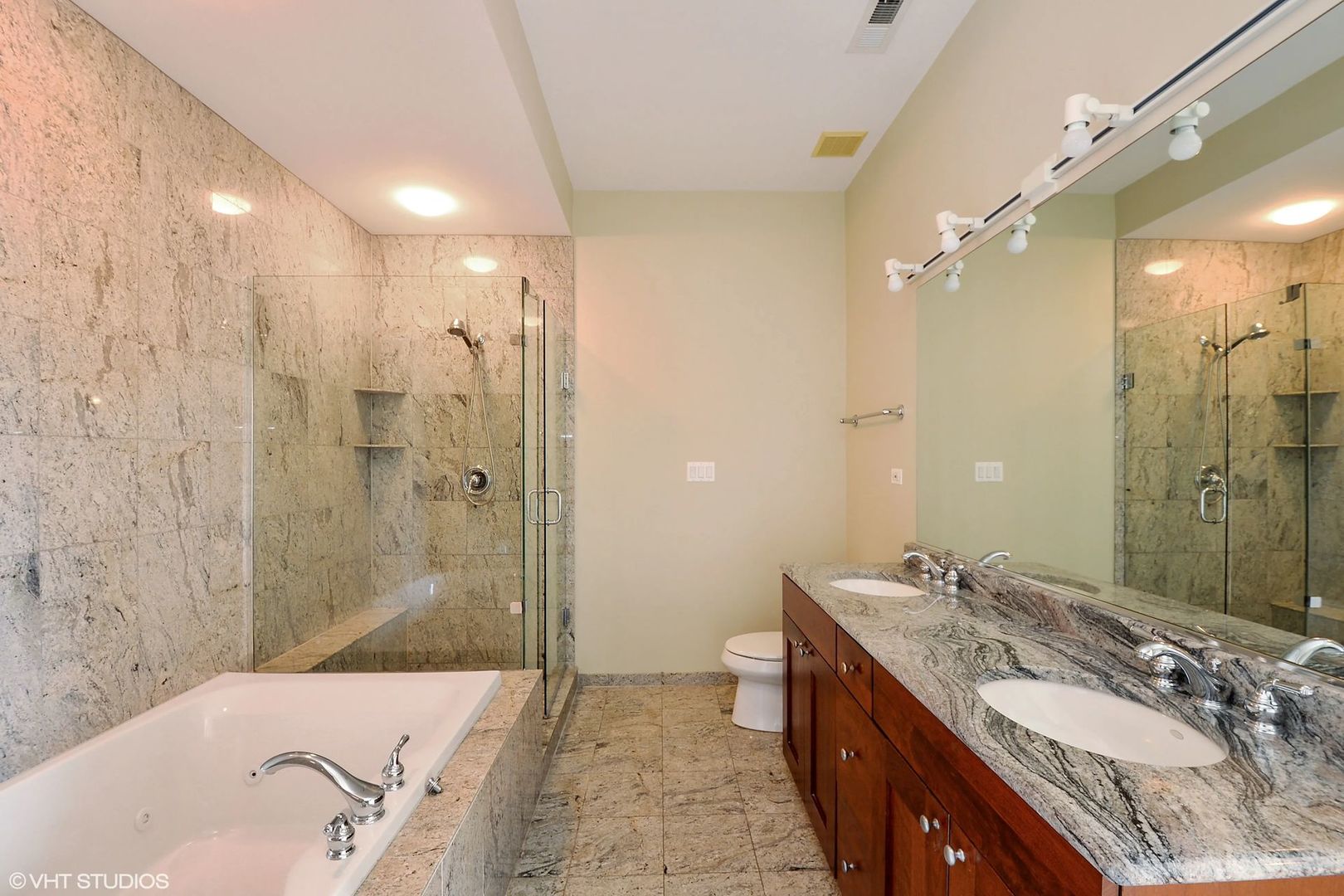 1355 West Washington Boulevard, Unit 6B Chicago, IL 60607 - Photo 16 of 28 a bathroom with a granite countertop tub sink shower and mirror