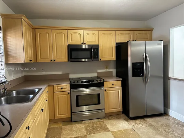 a kitchen with a refrigerator stove and microwave