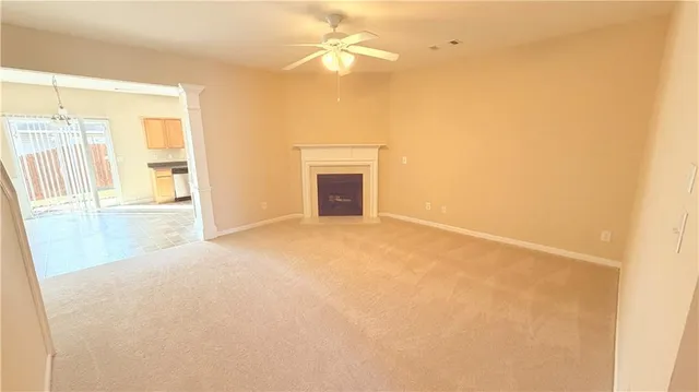 a view of empty room with a fireplace
