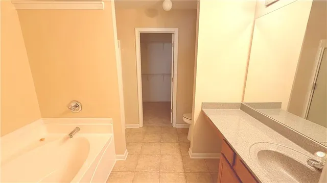 a bathroom with a tub sink and vanity