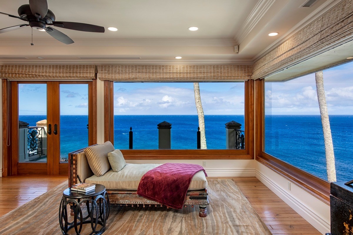 56-3083 Puakea Bay Road Kamuela, HI 96743 - Photo 20 of 30 a spacious bedroom with a balcony a bed and wooden floor