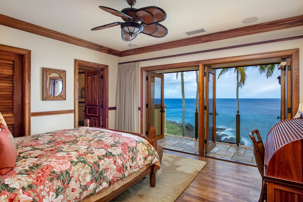 56-3083 Puakea Bay Road Kamuela, HI 96743 - Photo 23 of 30 a bedroom with a large bed and a chandelier