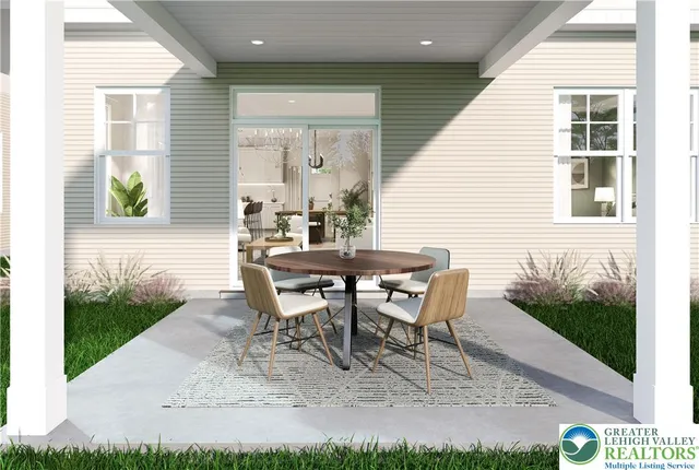 a view of a house with backyard and sitting area