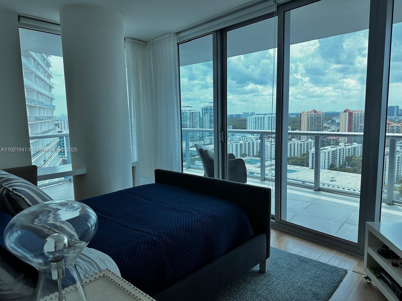 17001 Collins Avenue, Unit 2601 Sunny Isles Beach, FL 33160 - Photo 13 of 27 a bedroom with a bed and a window