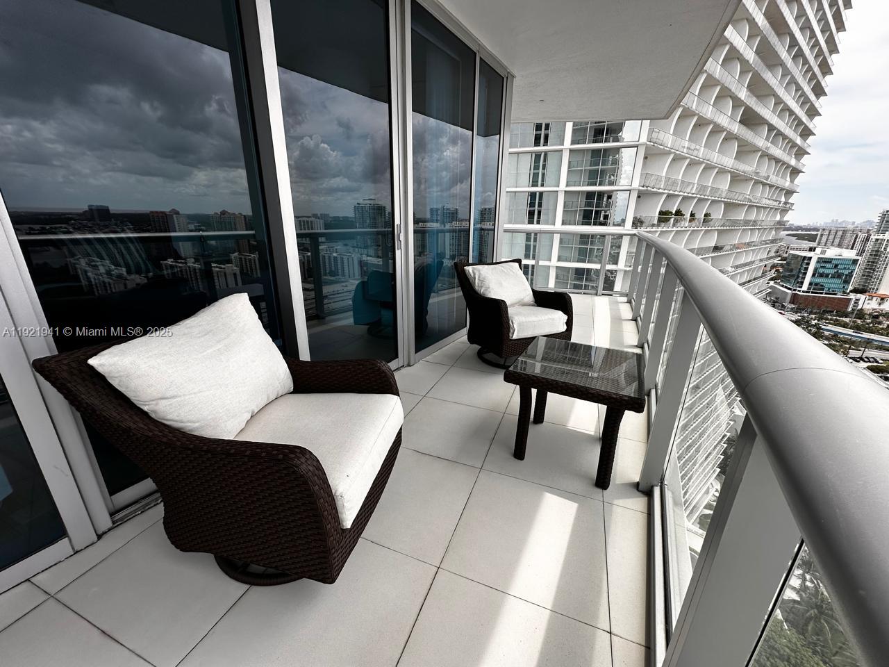 17001 Collins Avenue, Unit 2601 Sunny Isles Beach, FL 33160 - Photo 14 of 27 a balcony with table and chairs
