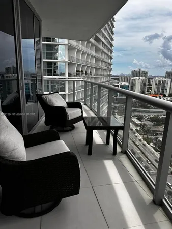 a view of a balcony with chair and table
