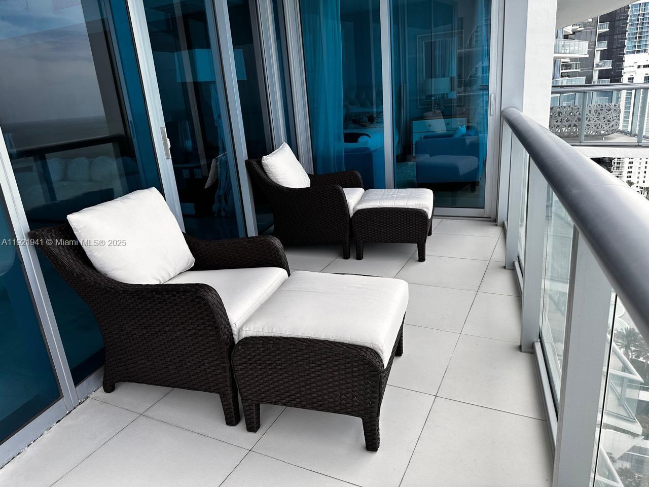 17001 Collins Avenue, Unit 2601 Sunny Isles Beach, FL 33160 - Photo 19 of 27 a balcony view with couple of chairs