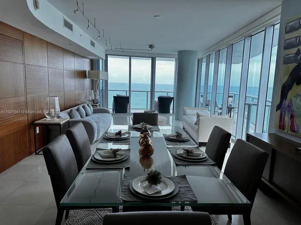 a view of a dining room with furniture and chandelier
