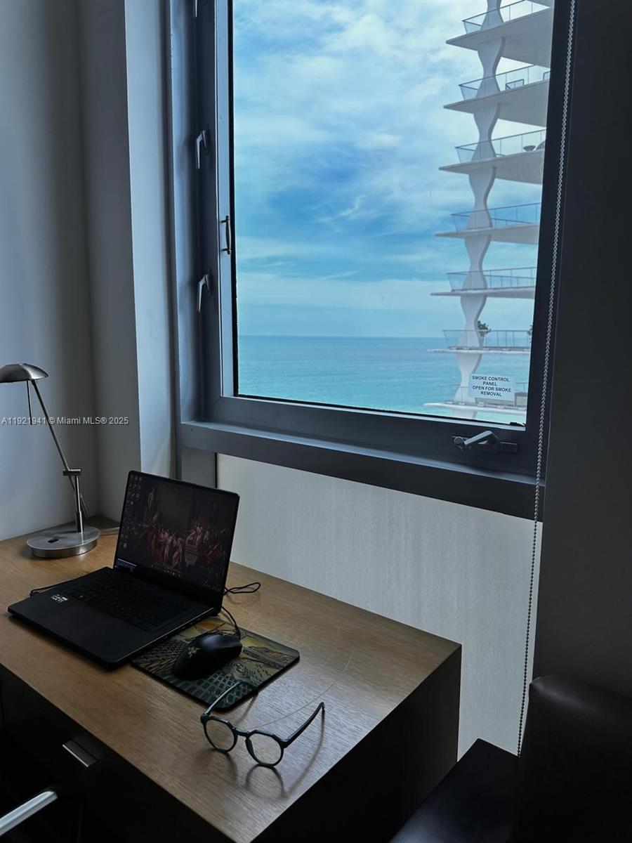 17001 Collins Avenue, Unit 2601 Sunny Isles Beach, FL 33160 - Photo 8 of 27 a laptop computer sitting on top of a table