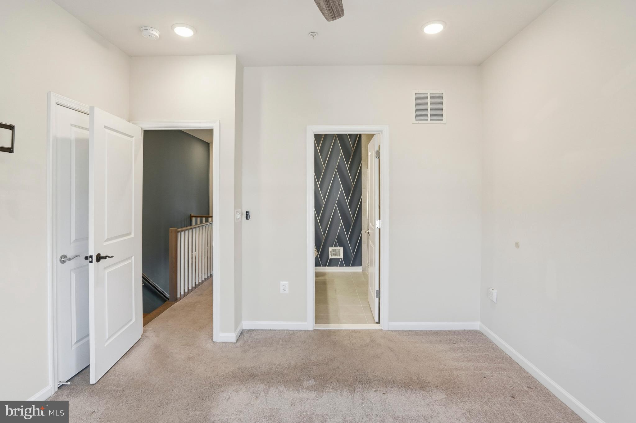 211 Narrowleaf Way Laurel, MD 20724 - Photo 17 of 36 an empty room with closet and mirror