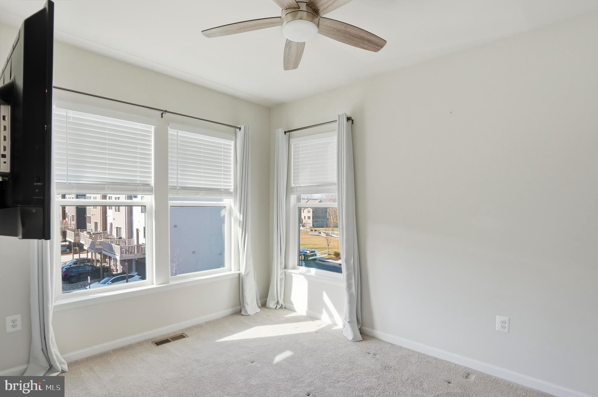 211 Narrowleaf Way Laurel, MD 20724 - Photo 22 of 36 a view of a room with a ceiling fan and windows