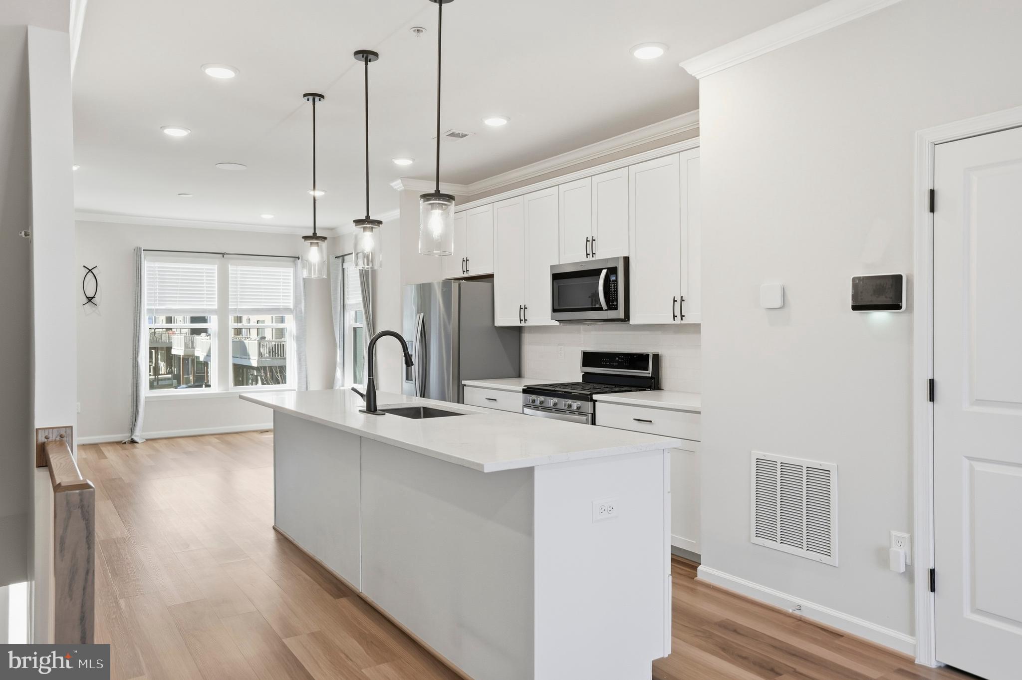 211 Narrowleaf Way Laurel, MD 20724 - Photo 10 of 36 a kitchen with kitchen island a white counter top space a sink and appliances