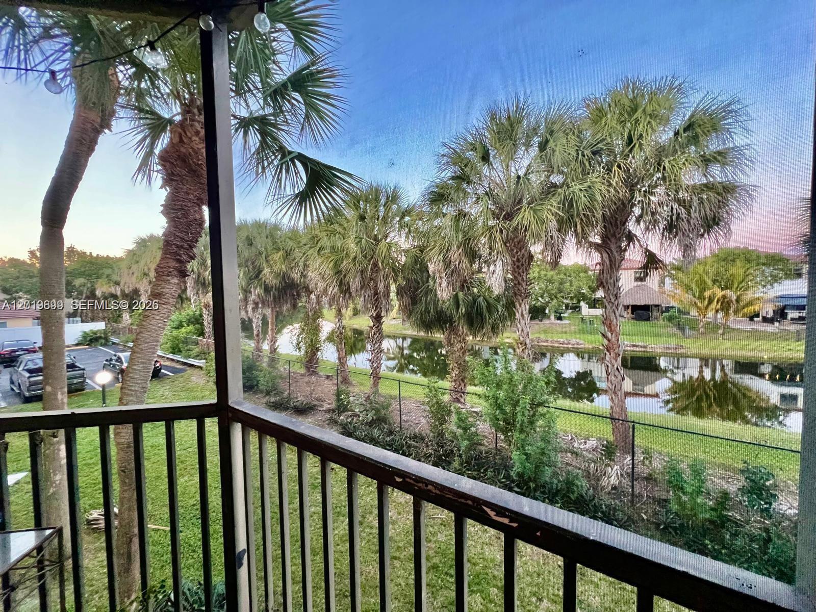 3470 Foxcroft Road, Unit 204 Miramar, FL 33025 - Photo 30 of 40 a view of a lake from a balcony