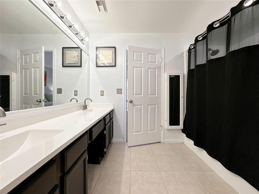 5202 Spring Cir Drive Pearland, TX 77584 - Photo 11 of 19 a spacious bathroom with a double vanity sink and mirror