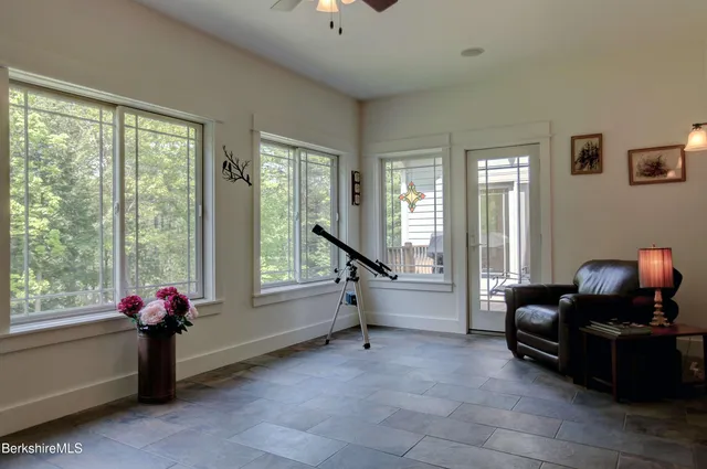 a living room with furniture stairs and a window