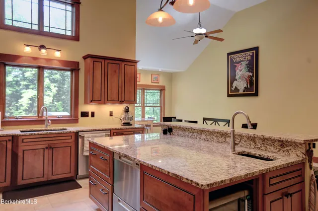 a kitchen with a sink a stove and a microwave
