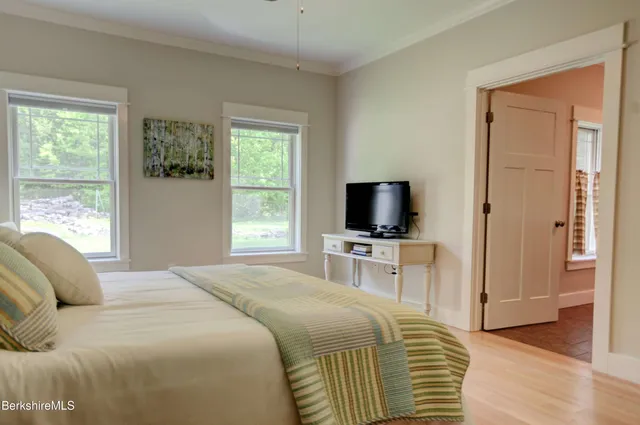 a bedroom with a bed and a television