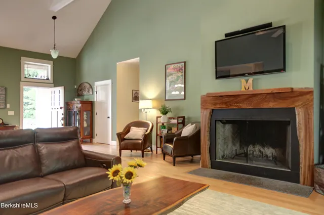 a living room with furniture a flat screen tv and a fireplace