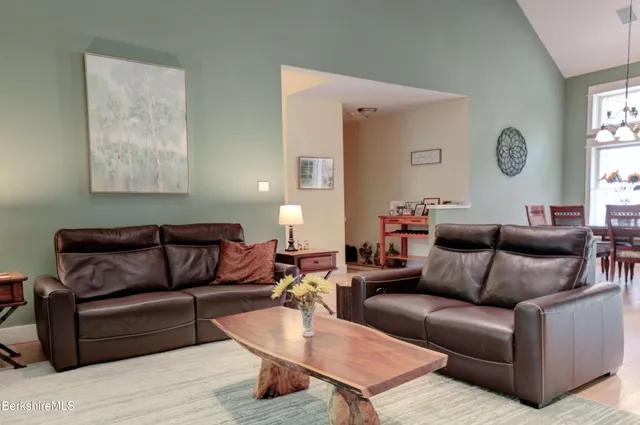 a living room with furniture a rug and a window