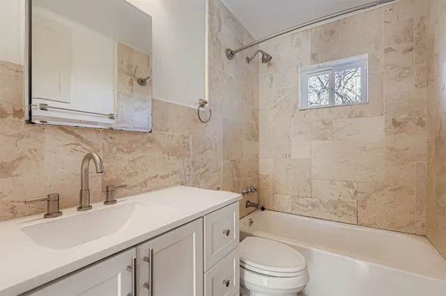 a bathroom with a sink a toilet and bathtub