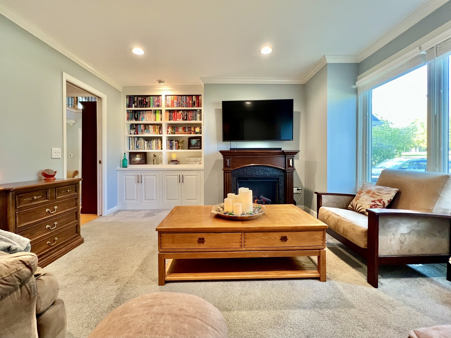 4111 Steeple Run Crystal Lake, IL 60014 - Photo 12 of 50 a living room with furniture a flat screen tv and a fireplace