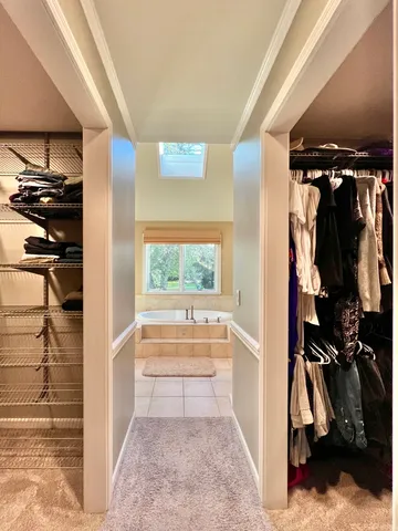a spacious bathroom with bathtub and window