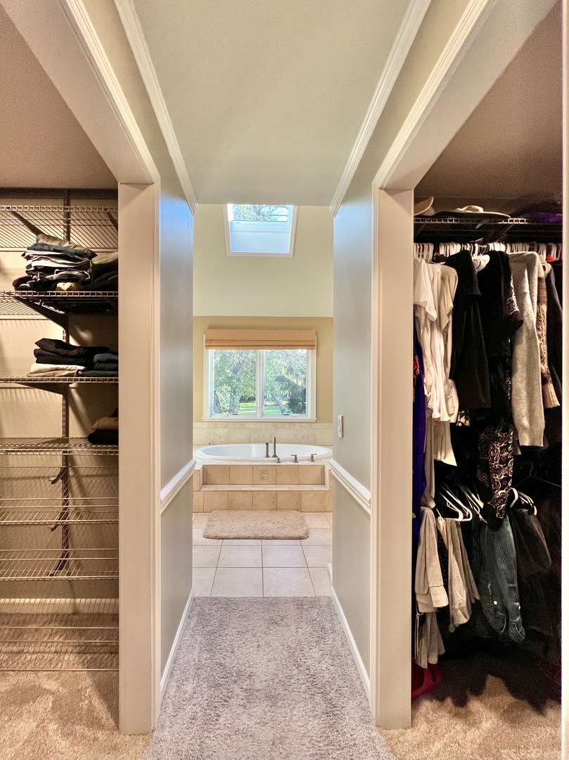 4111 Steeple Run Crystal Lake, IL 60014 - Photo 16 of 50 a view of walk in closet with clothes and shoes