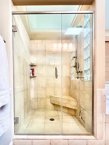 a spacious bathroom with a tub a sink and a large mirror