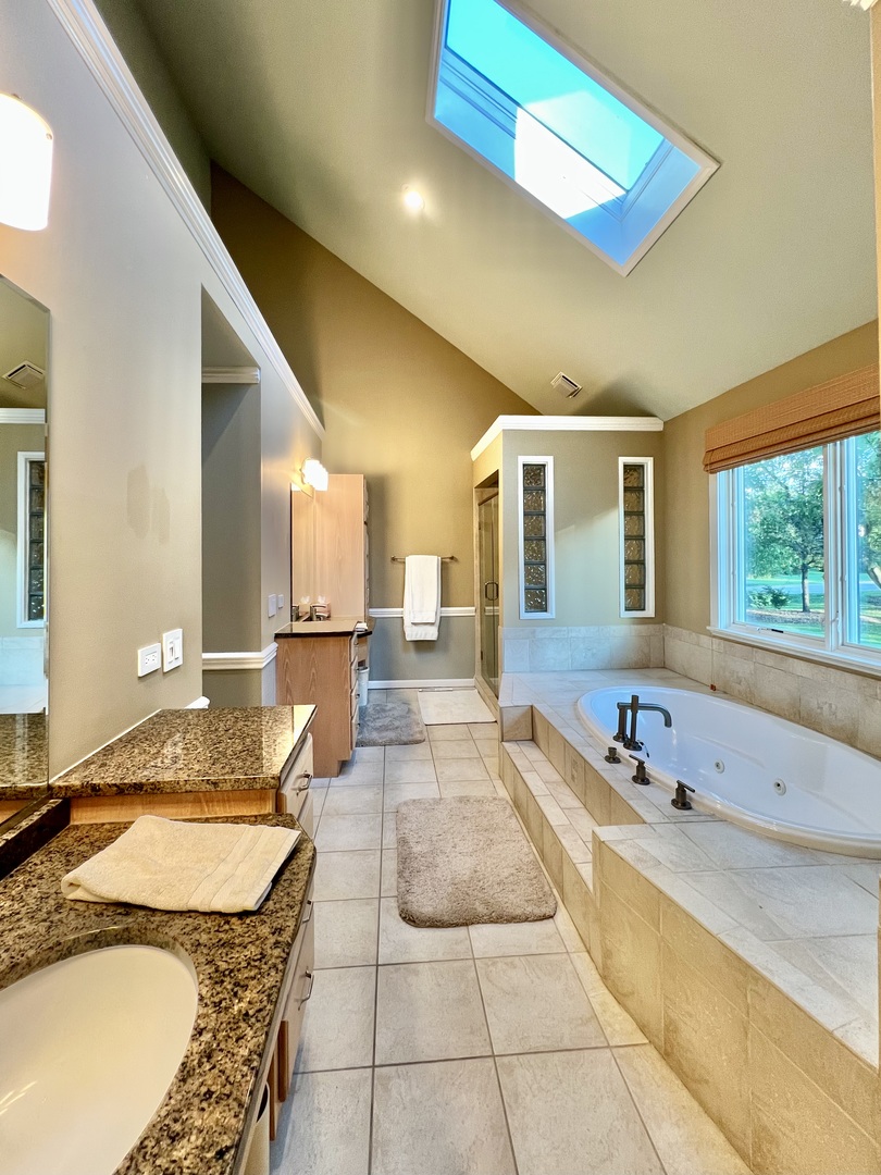 4111 Steeple Run Crystal Lake, IL 60014 - Photo 20 of 50 a spacious bathroom with a granite countertop tub and a sink