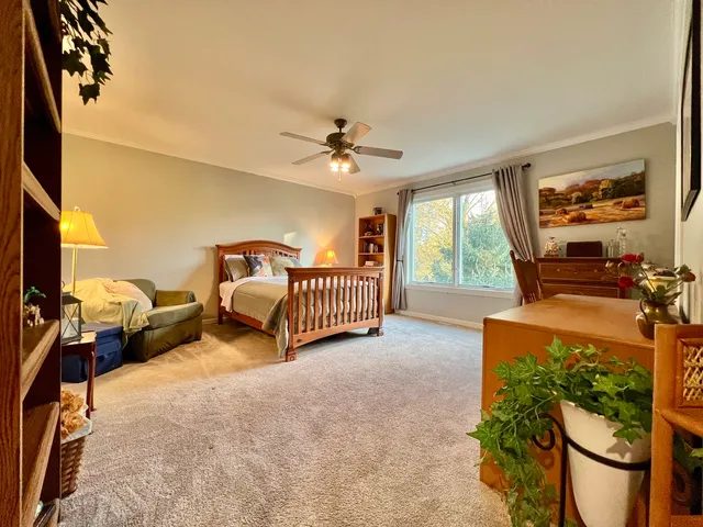 a bed room with a bed and a chair