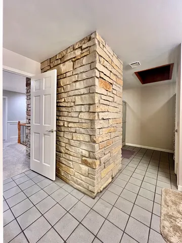 a spacious bathroom with a sink and a mirror