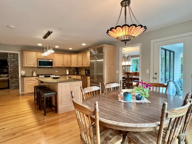 a view of a dining room with furniture wooden floor and chandelier