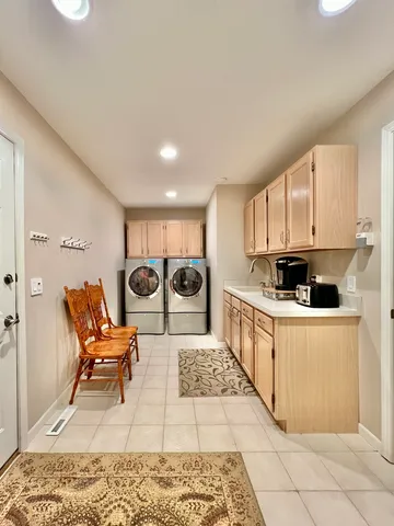 a large white kitchen with a stove a sink a table and chairs